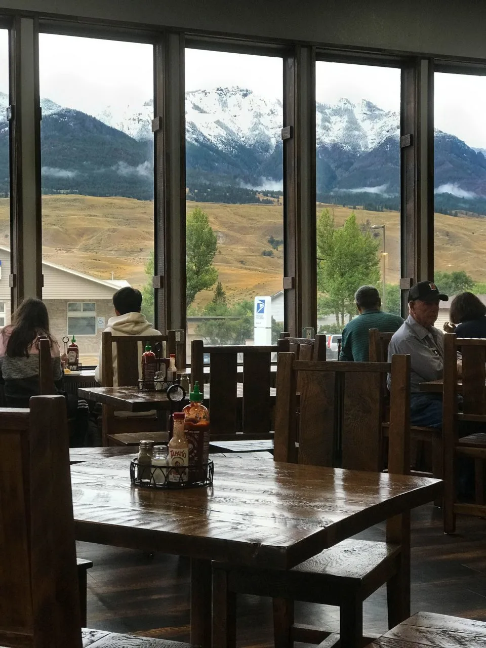 The breakfast dining room at the Gardiner MT Super 8 Hotel with a beautiful view of the hills and snowcapped mountains.