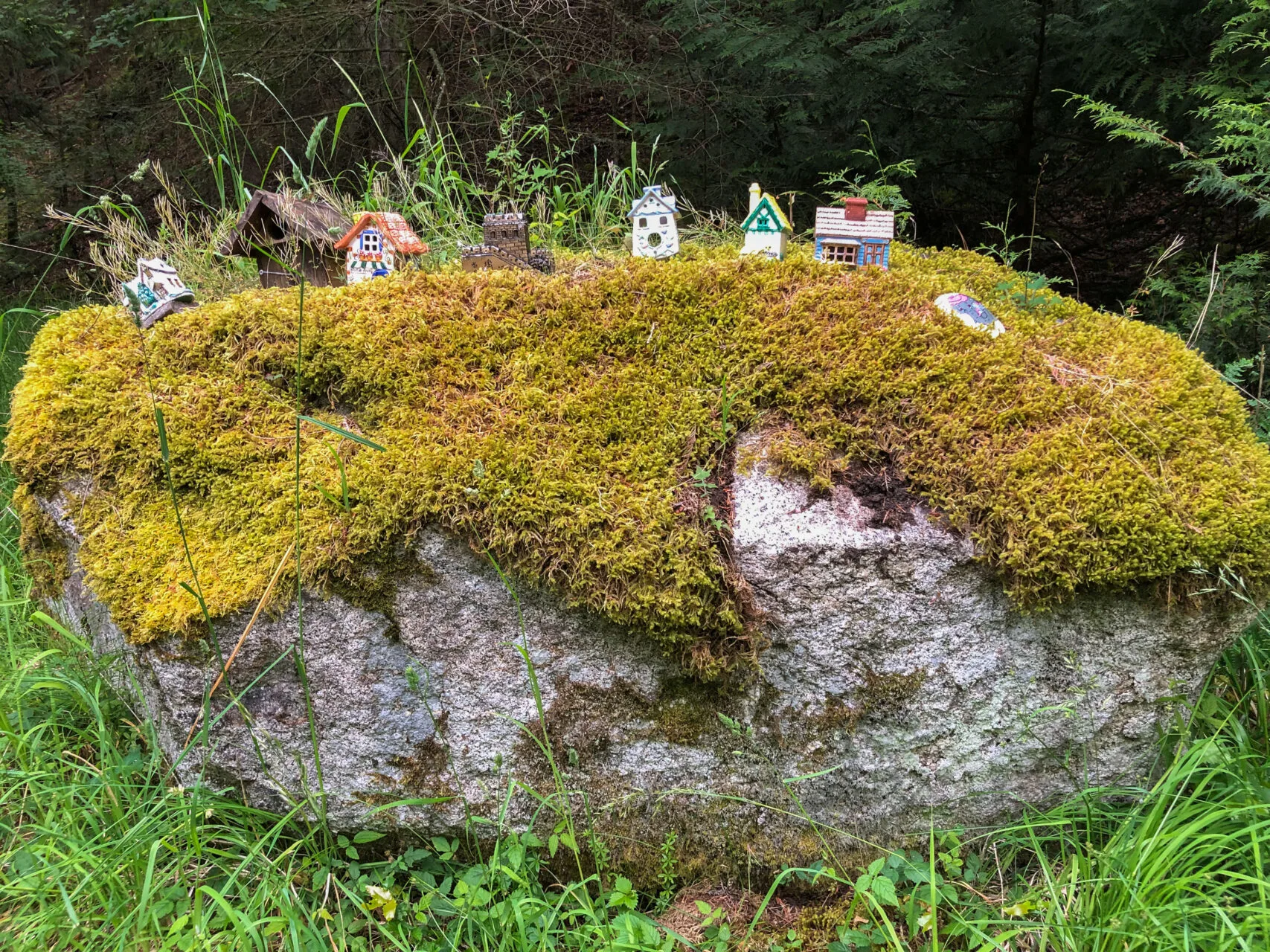 Driving or biking on San Juan Island, you'll find all kinds of whimsical things like these small ceramic houses on a moss-covered rock.
