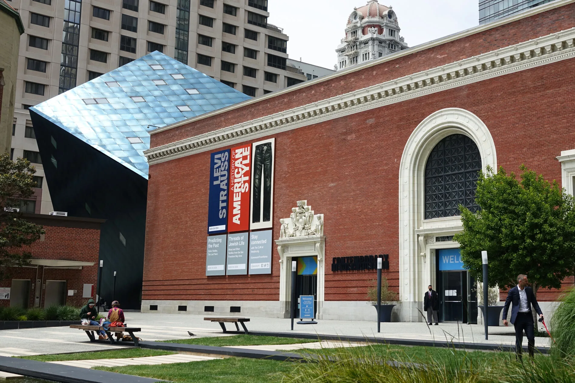 Striking Contemporary Jewish Museum building with a modern blue steal cube addition added to a restored brick powerhouse.