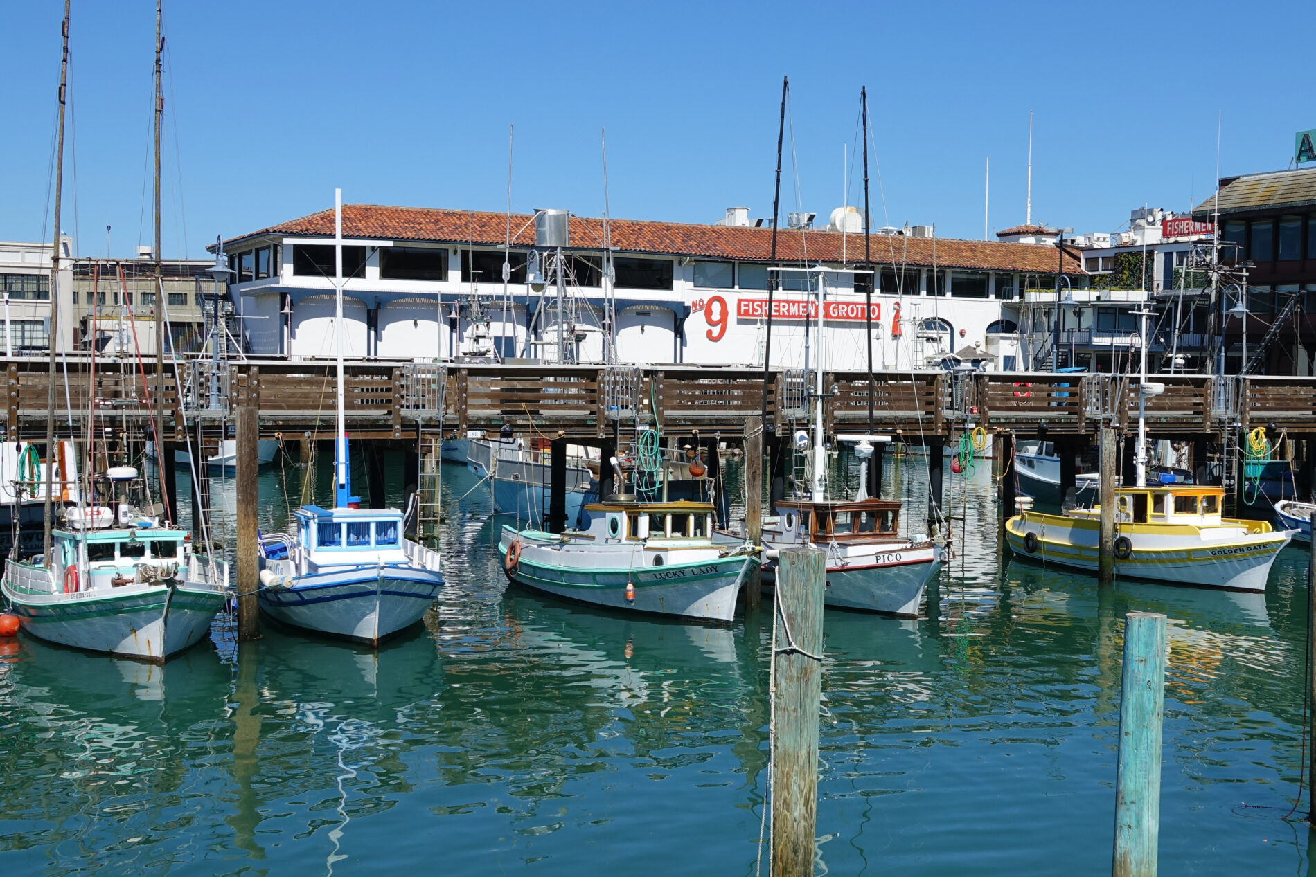 Colorful fishing boats docked at Fisherman’s Wharf in San Francisco.