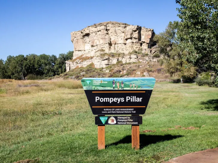 The Pompey's Pillar sign in front of the rock where Clark's signature still lies.