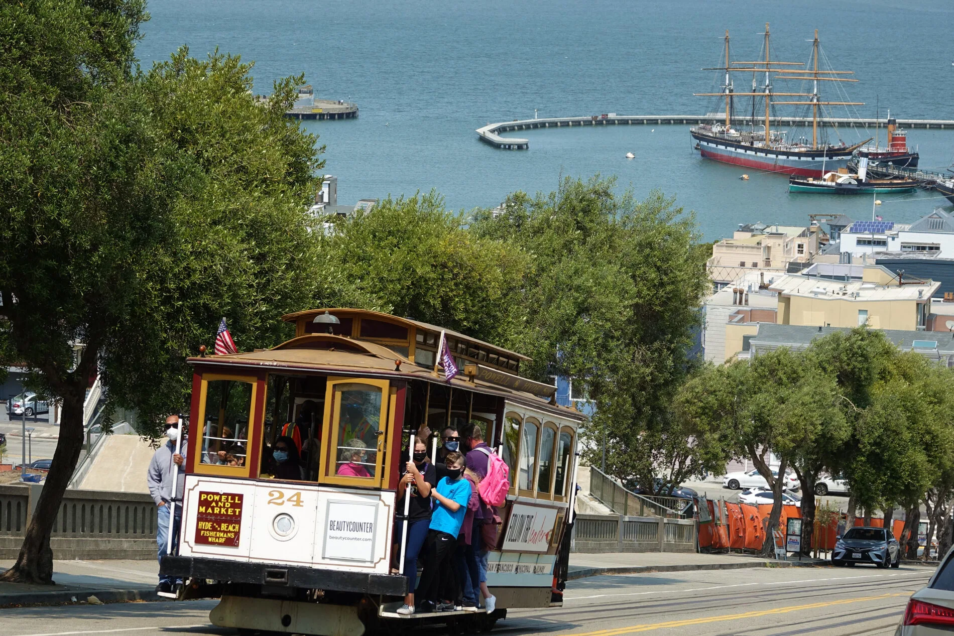 Riding a cable car to Fisherman's Wharf. It’s a must-do attraction in San Francisco.