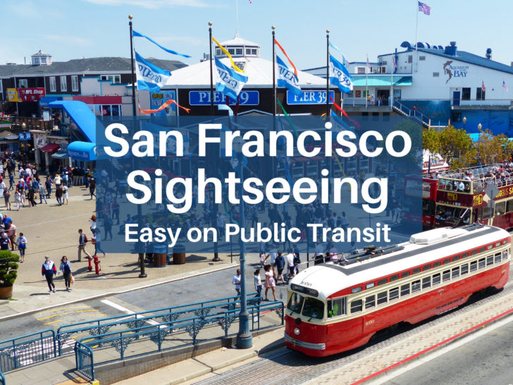 A bright red historic street car arrives at Pier 39 in San Francisco.
