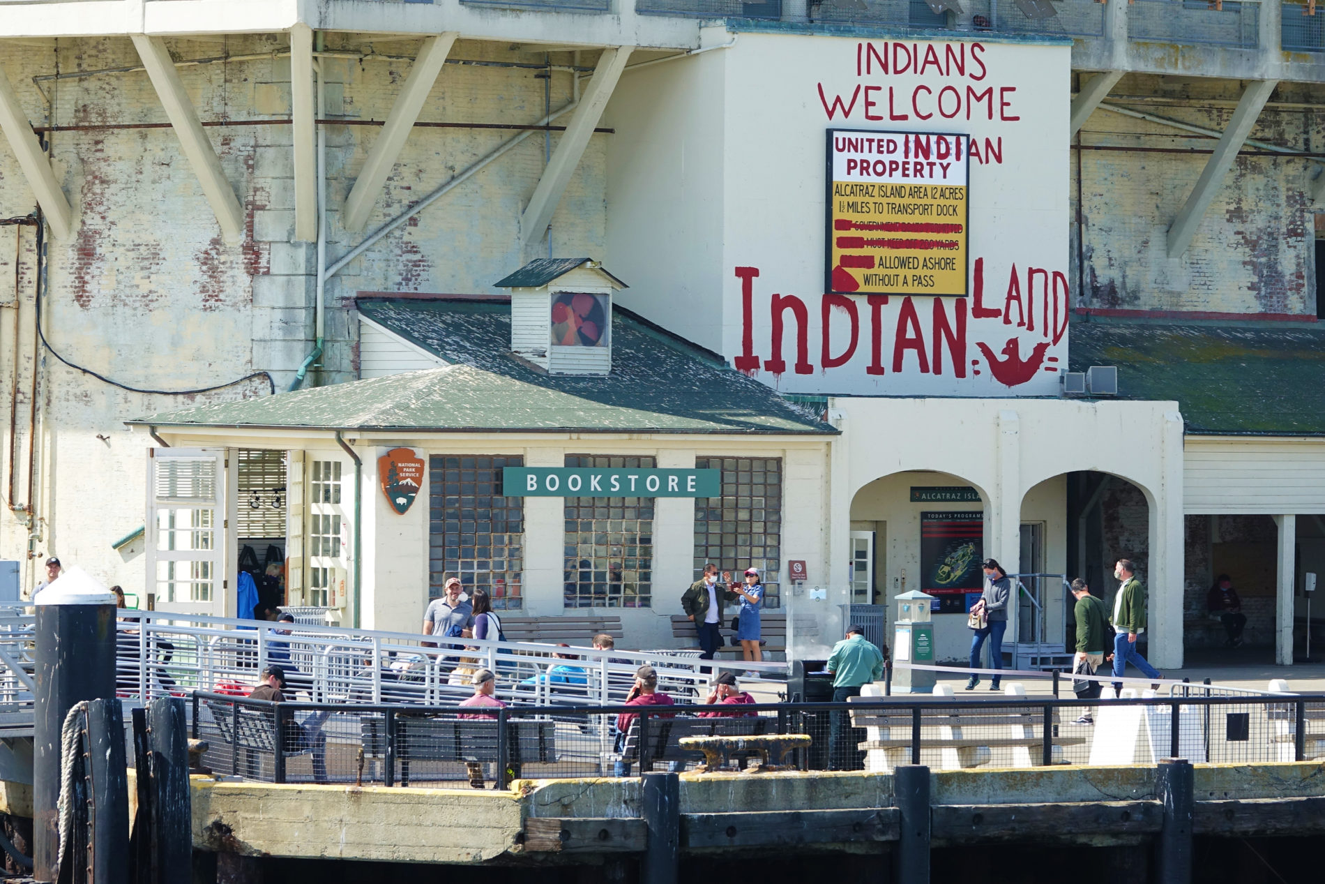 The dock and bookstore on Alcatraz with a red Indians Welcome sign. It’s a remnant left from the 1969 Indian Occupation.