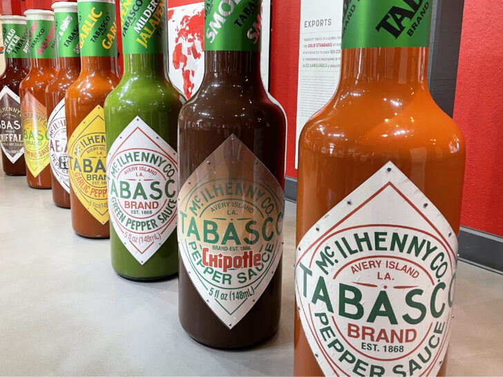 A Tabasco Factory display with a row of seven human-size bottles representing each of the seven Tabasco flavors.
