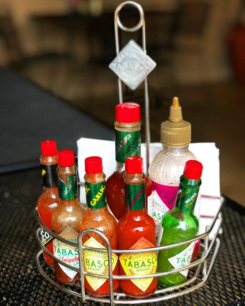 Bottles of the seven Tabasco Sauce flavors in a convenient metal caddy.