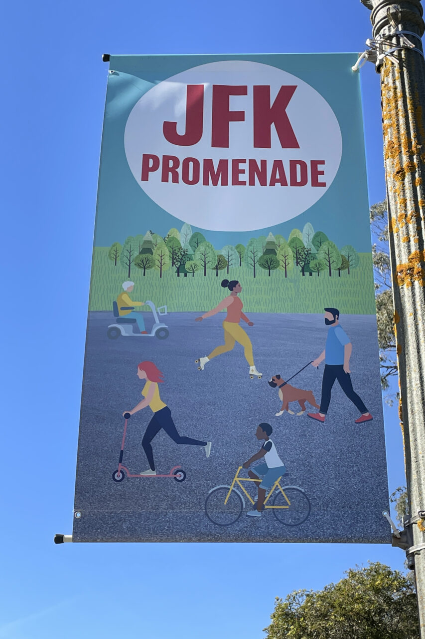 Colorful banners on JFK Promenade show things to do in golden gate park like walking, running, biking, and walking dogs.