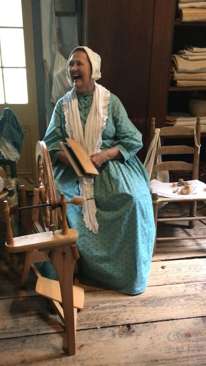 A Vermillionville docent that spins wools into threads then weaves them into garments.