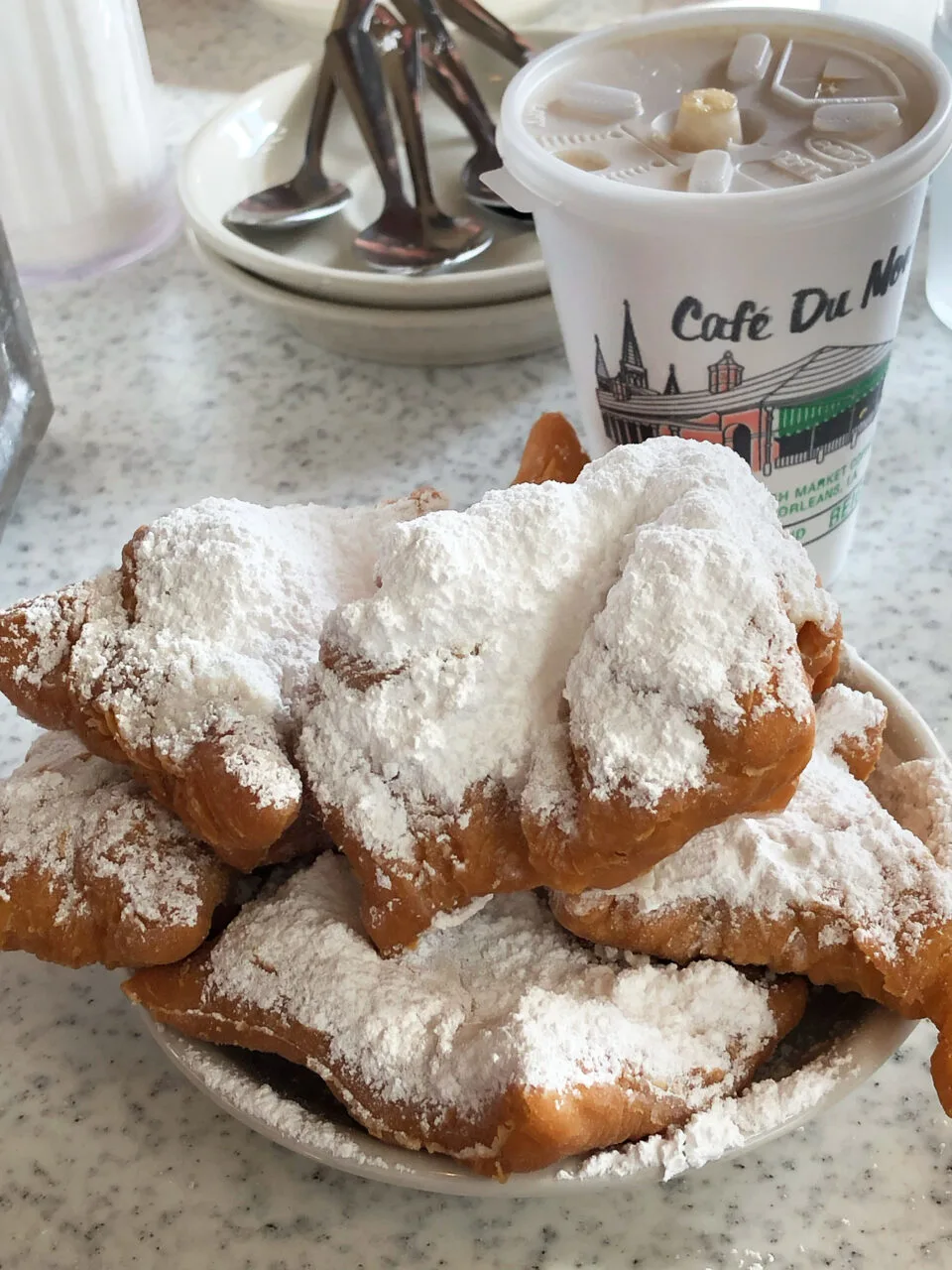 Beignets from Cafe du monde, a great Cajun and creole food to try in New Orleans.