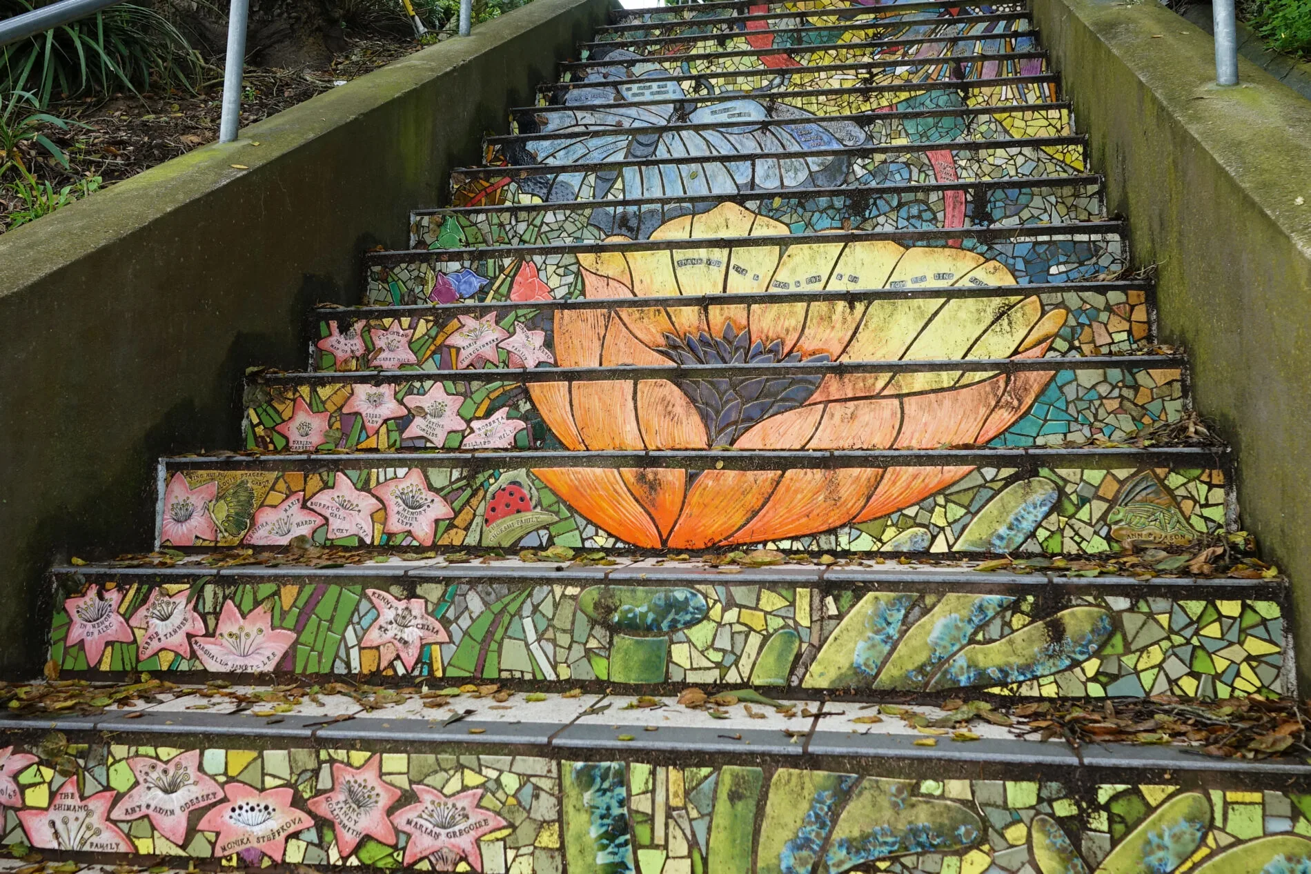 A huge poppy and blue moth in the mosaic tile mural on the Hidden Garden Steps in San Francisco.