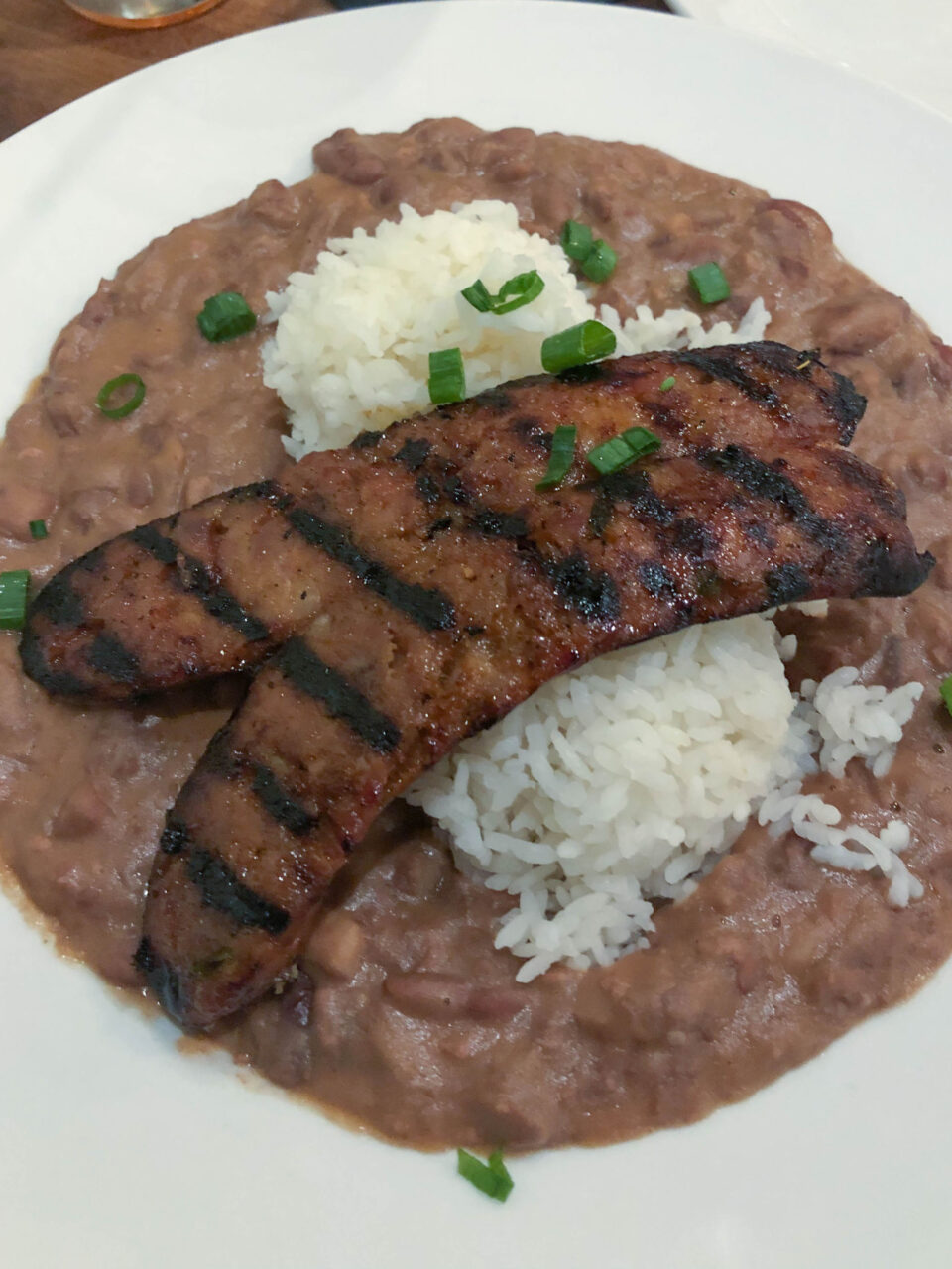 Red beans and rice, this one topped with sausage, is a Louisiana Cajun staple.