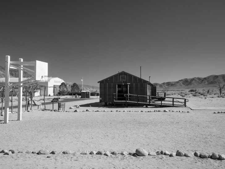 One of the old dormitory blocks, a basketball net, and the visitor center are some of the only remnants from Manzanar Japanese Internment Camp.